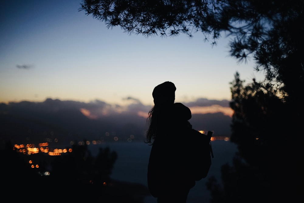 silhouette view of woman carrying backpack