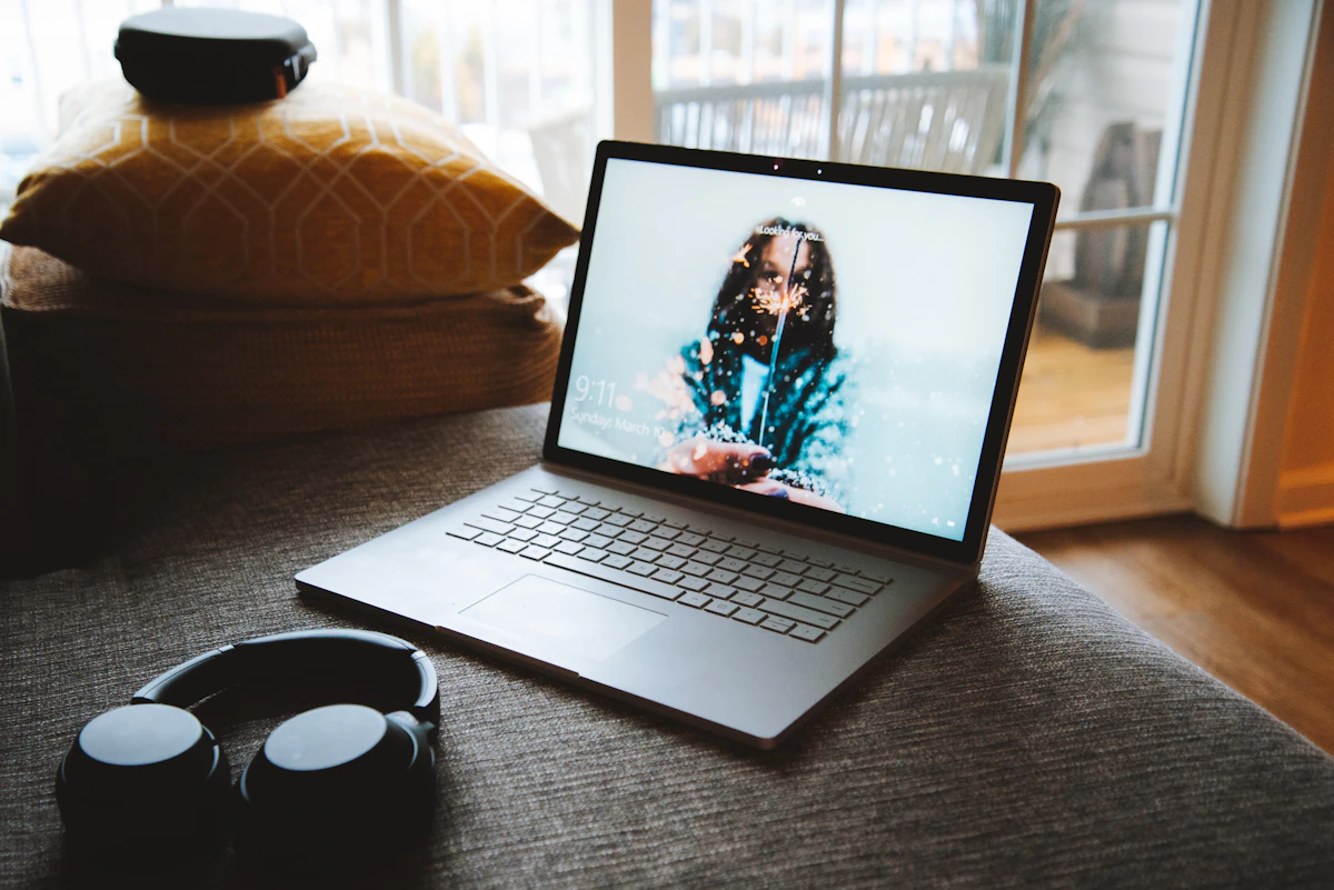Someone watching a livestream on a laptop in a cozy room