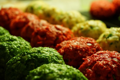 A close-up shot of colorful sports balls arranged neatly on a wooden surface.