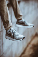 Close-up of a pair of modern sneakers on a concrete ledge with soft natural light