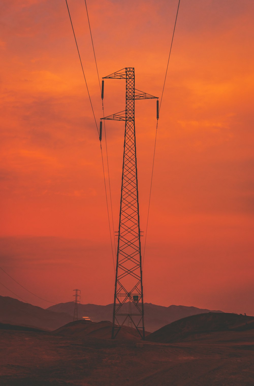 silhouette photography of electrical post during golden hour