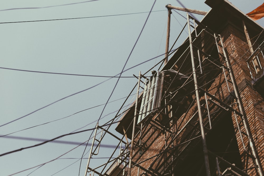 a tall brick building with lots of power lines