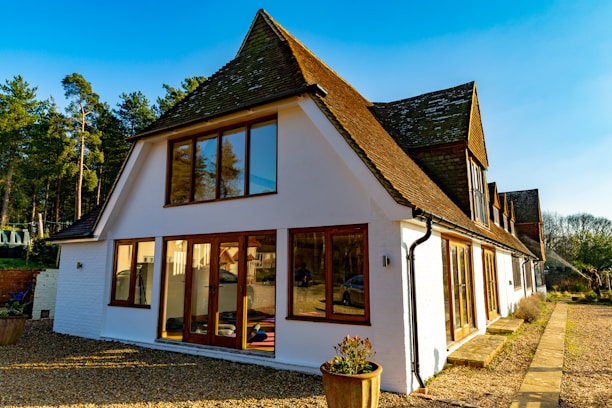 A modern farmhouse-style home with freshly excavated land and smooth grading around the foundation.