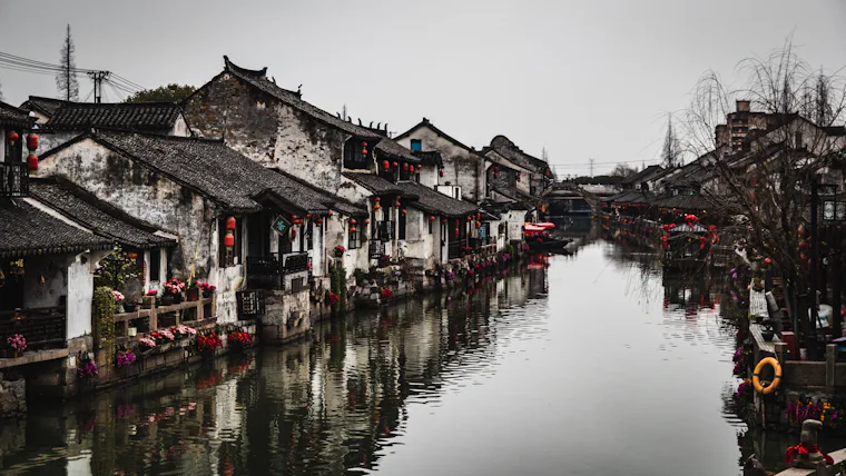 White and black house beside the water