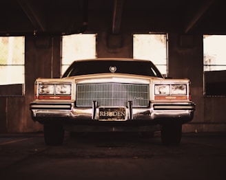 A vintage car parked beside a friendly DMV service counter with paperwork and title documents.