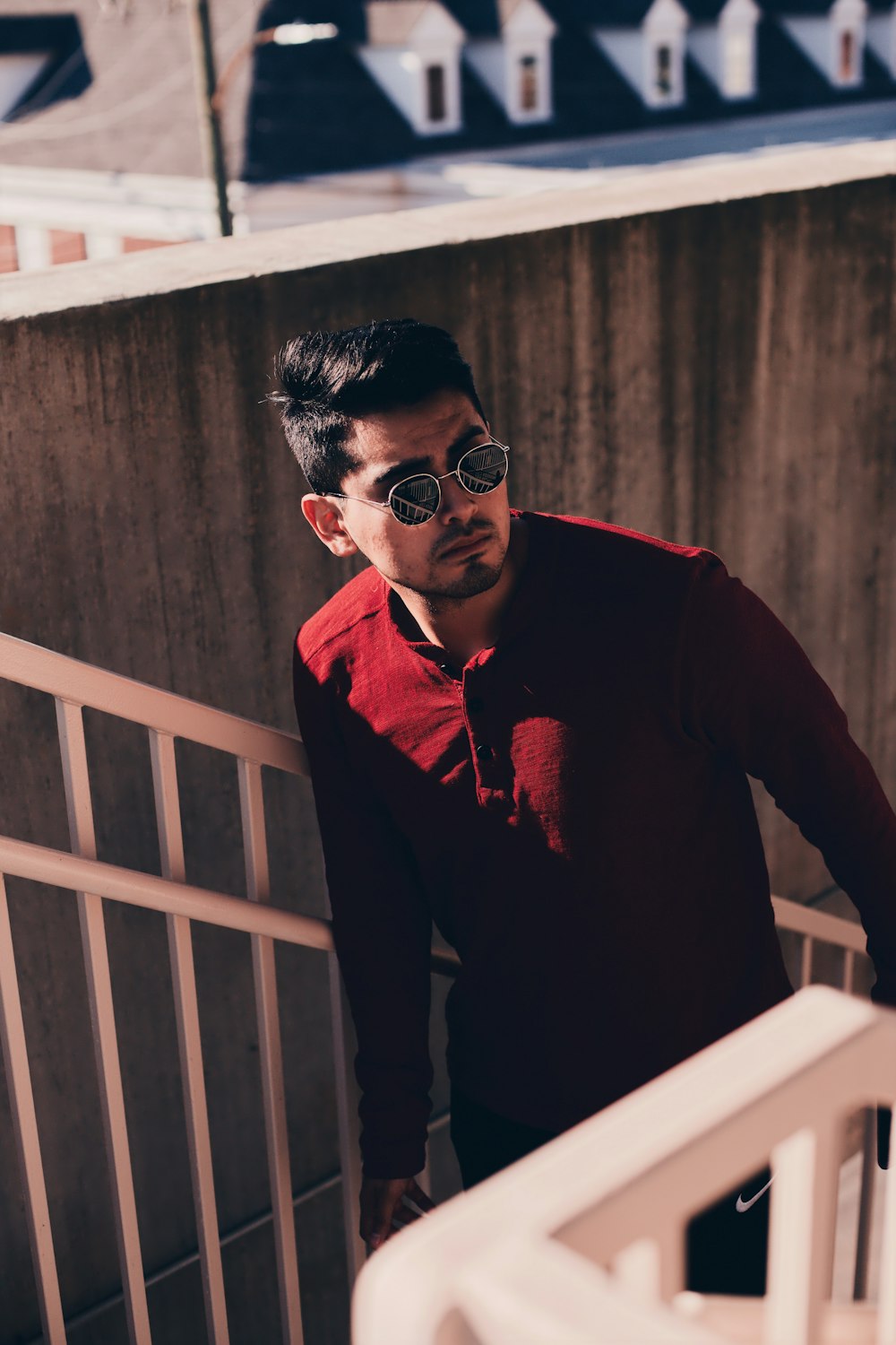 man in red beside stairs