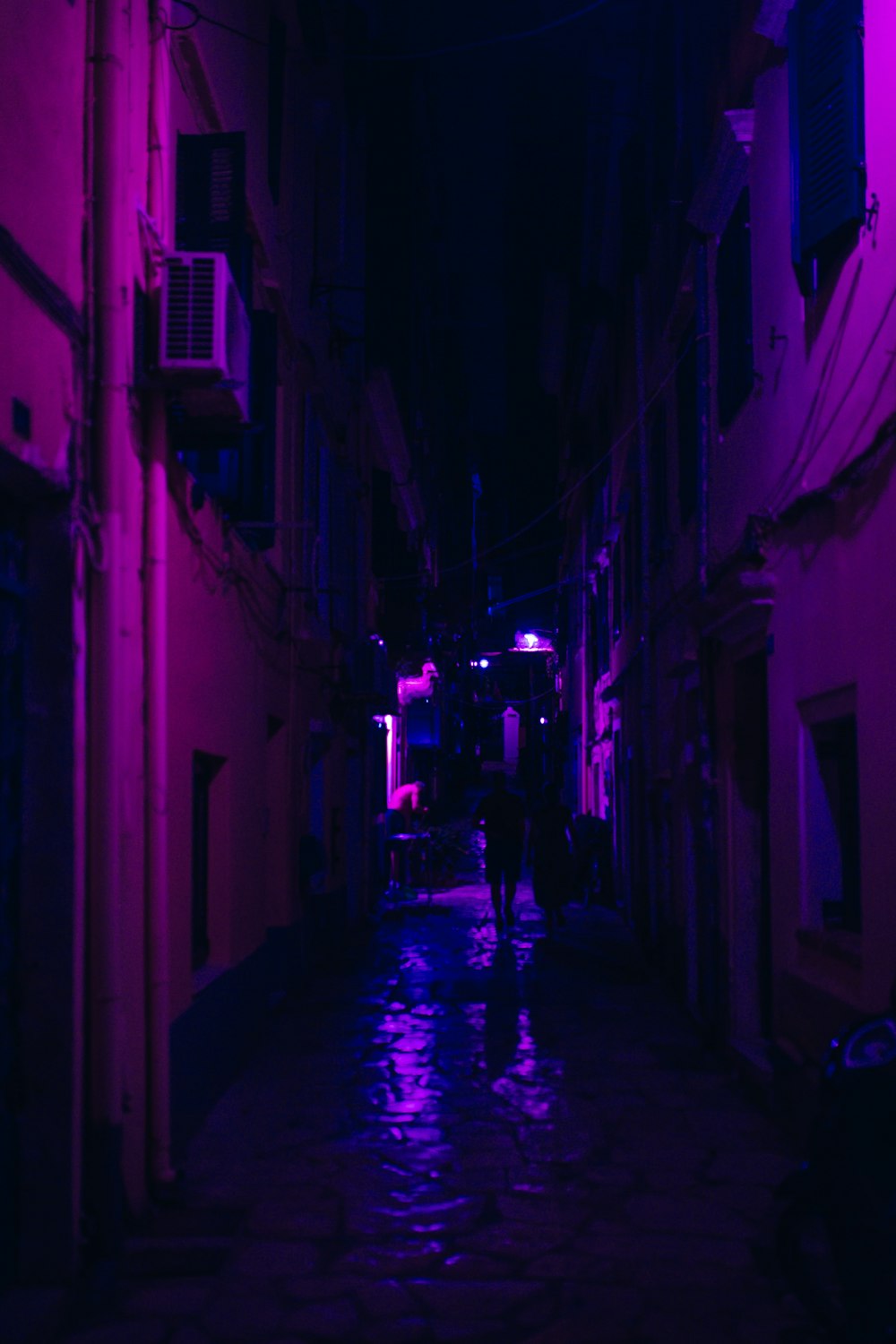 a person walking down a dark alley way