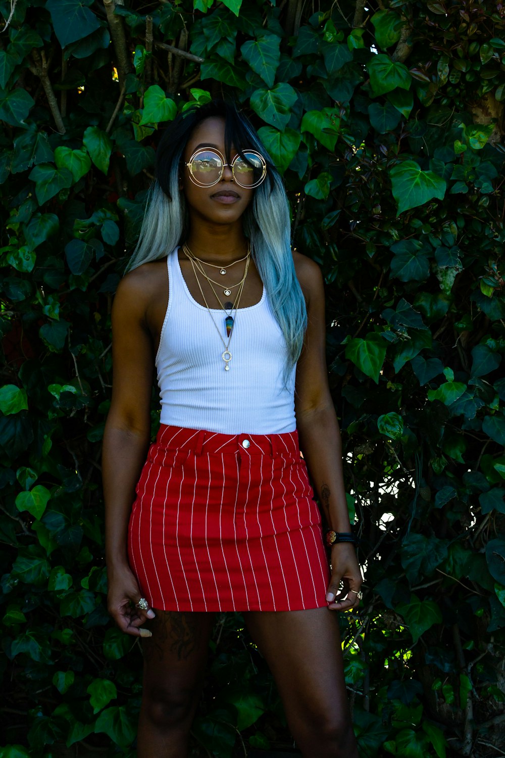 women's white tank top and red skirt