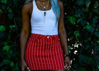 women's white tank top and red skirt