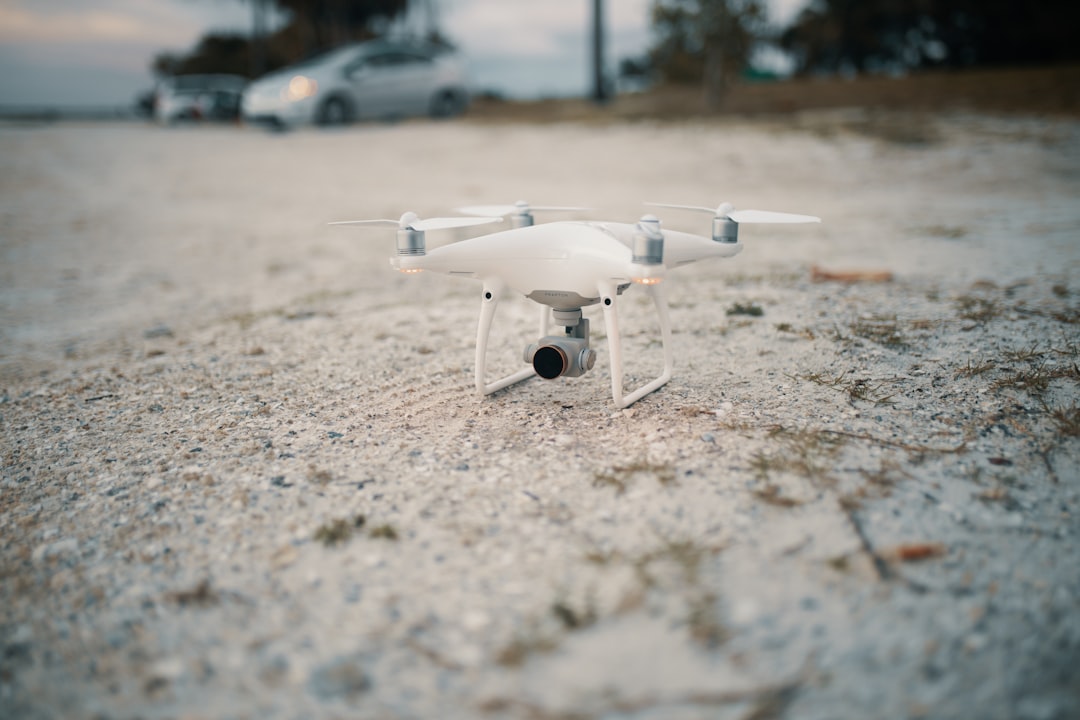 white and gray drone on ground