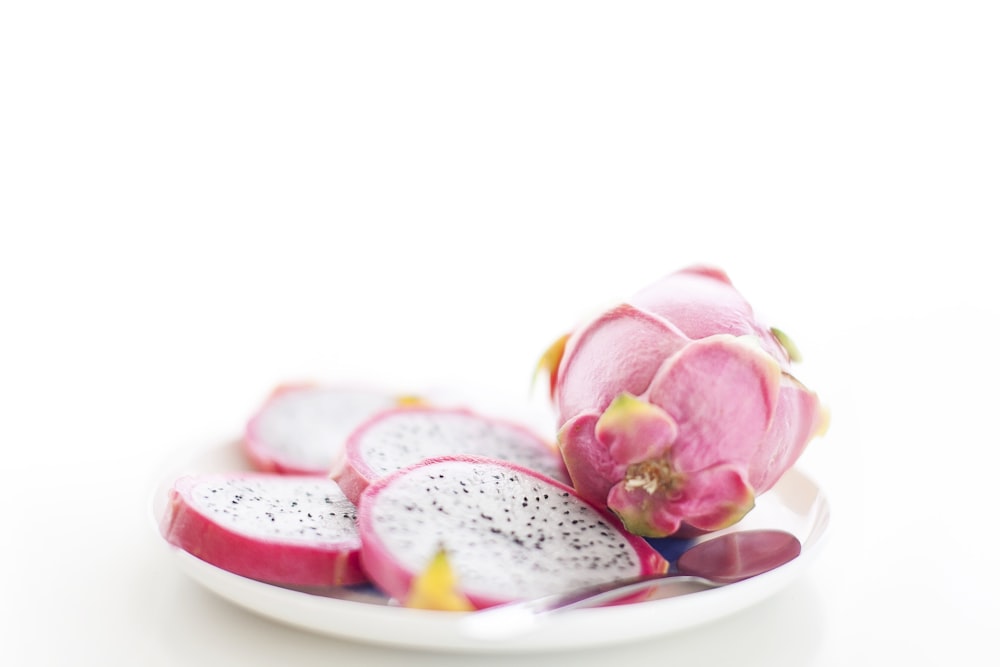 sliced pink fruit in plate