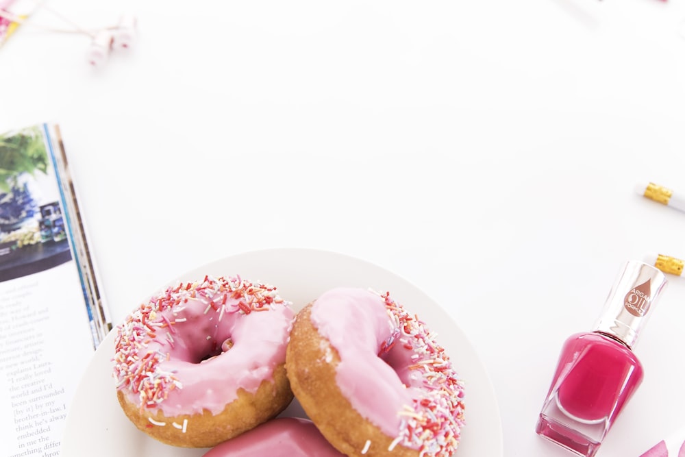 pink glazed donuts on a plate