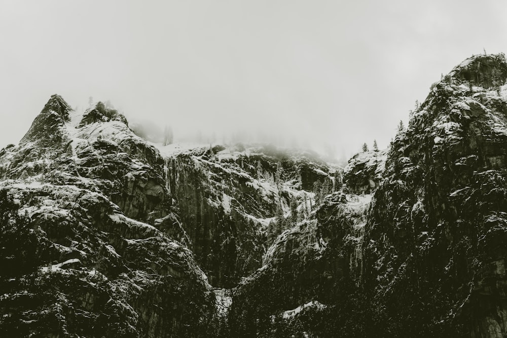 grayscale photo of mountain cover with snow