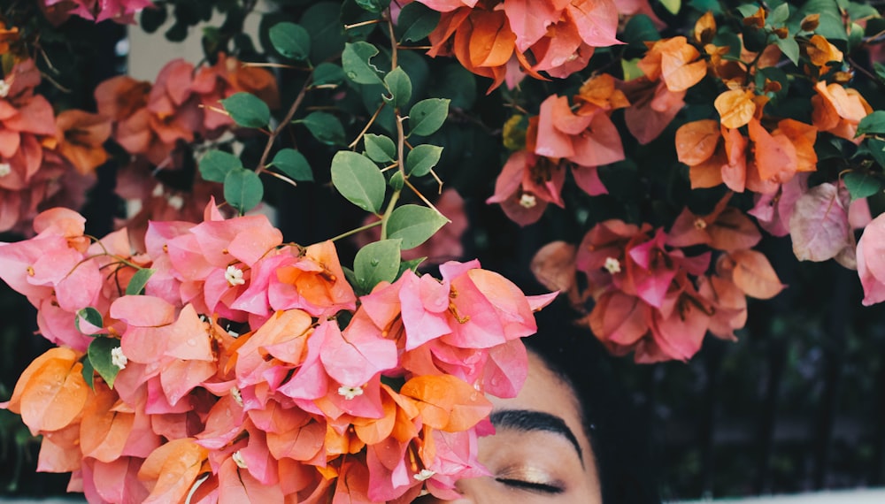 woman hiding behind bougainvillea flowers