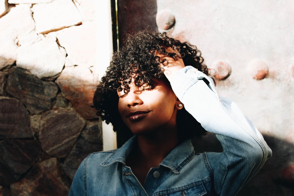 woman holding hair using left hand