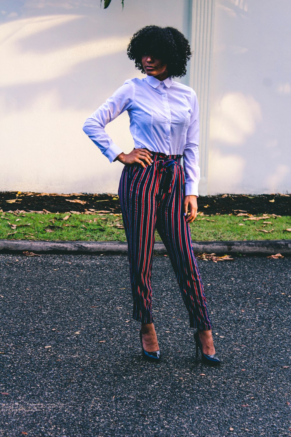 woman standing on asphalt road