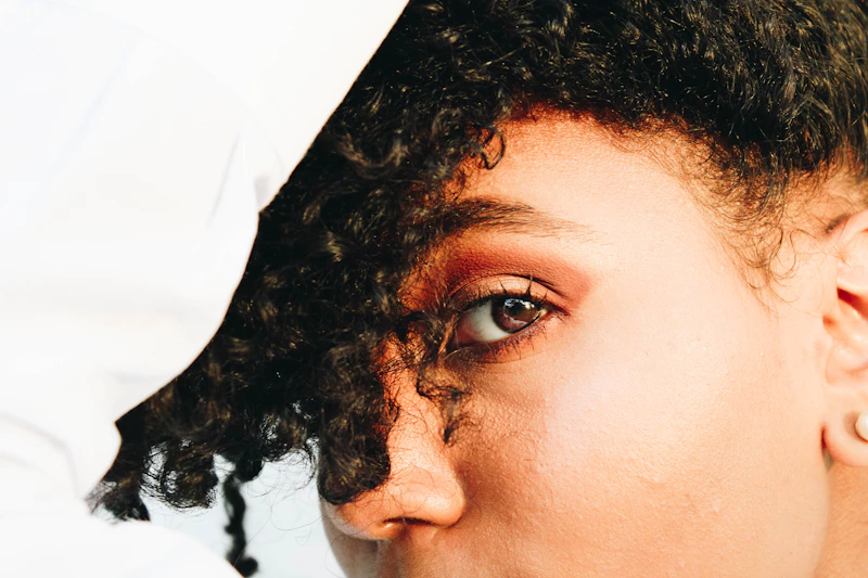 person with black curly hair close-up