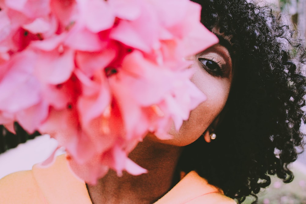 woman behind pink flowers