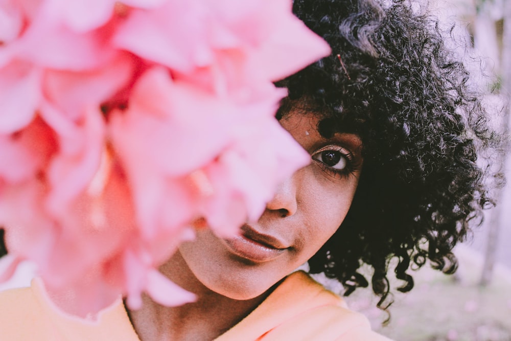 woman standing near the pink petaled flower photography