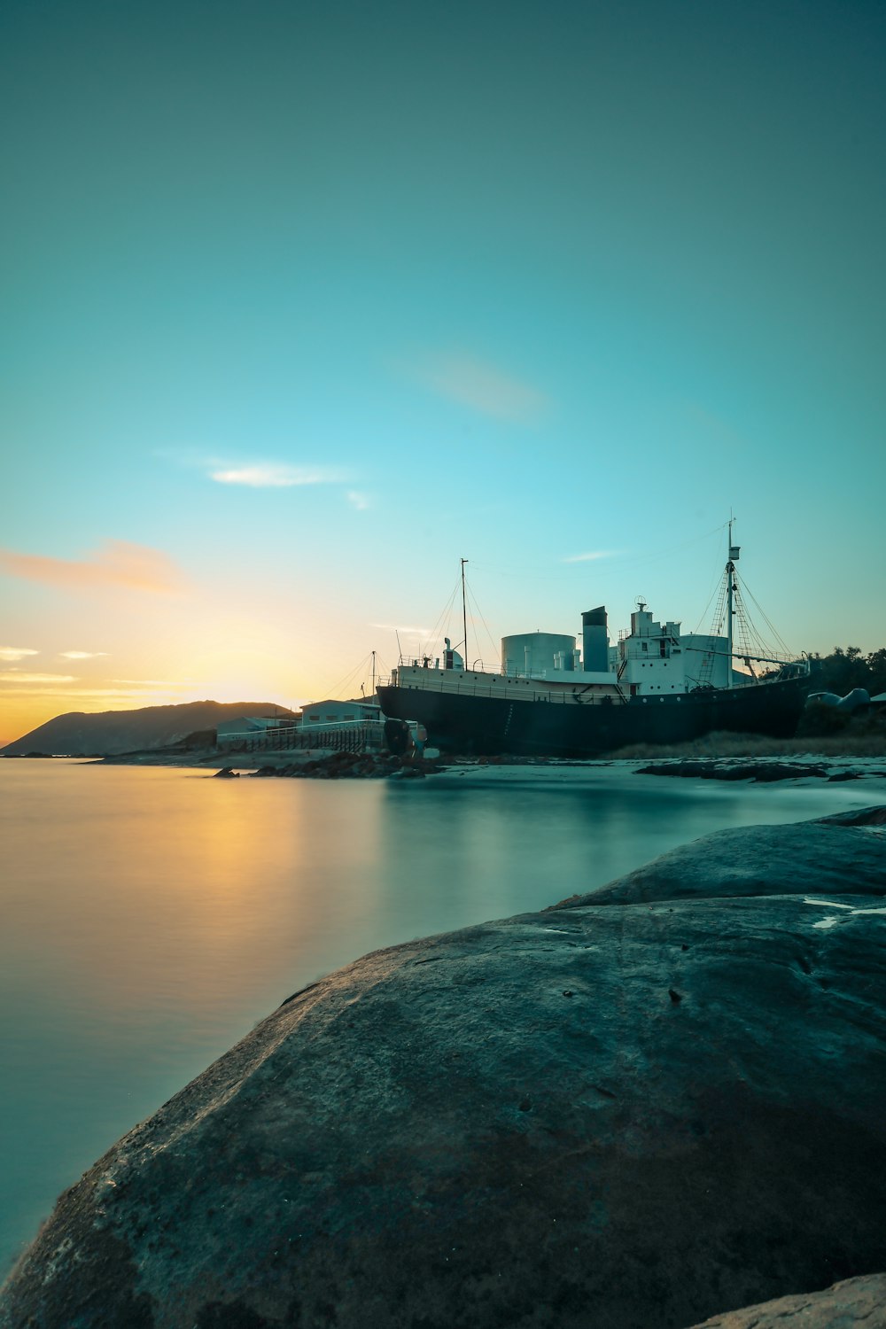 black ship near shoreline