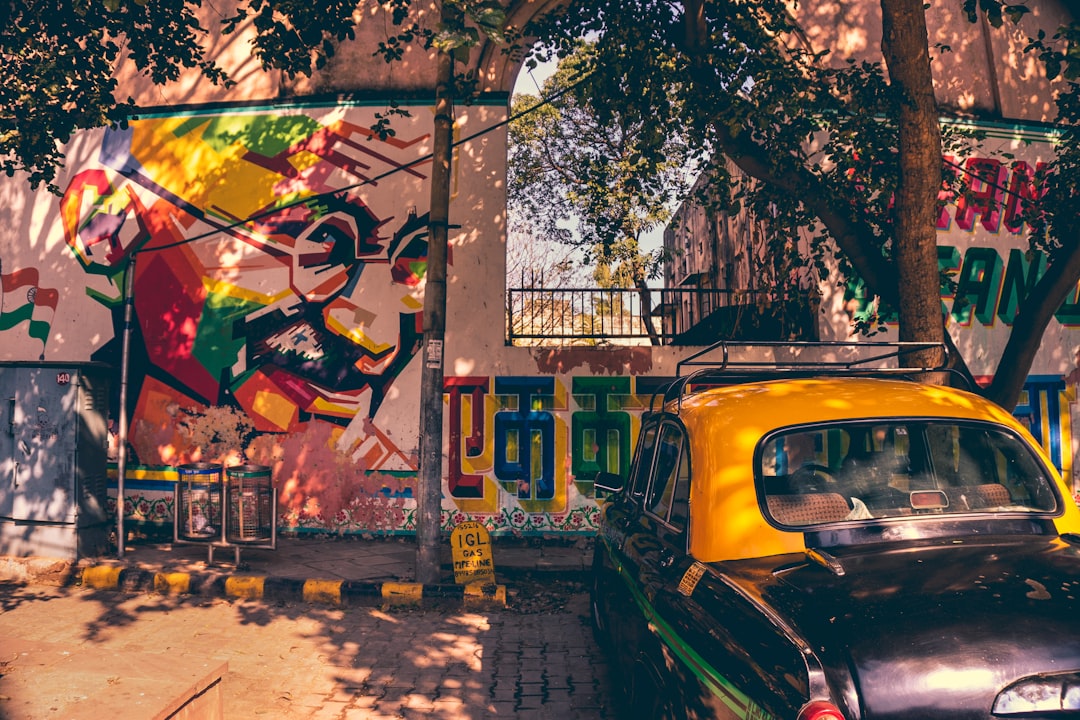 yellow and black Volkswagen Beetle near wall