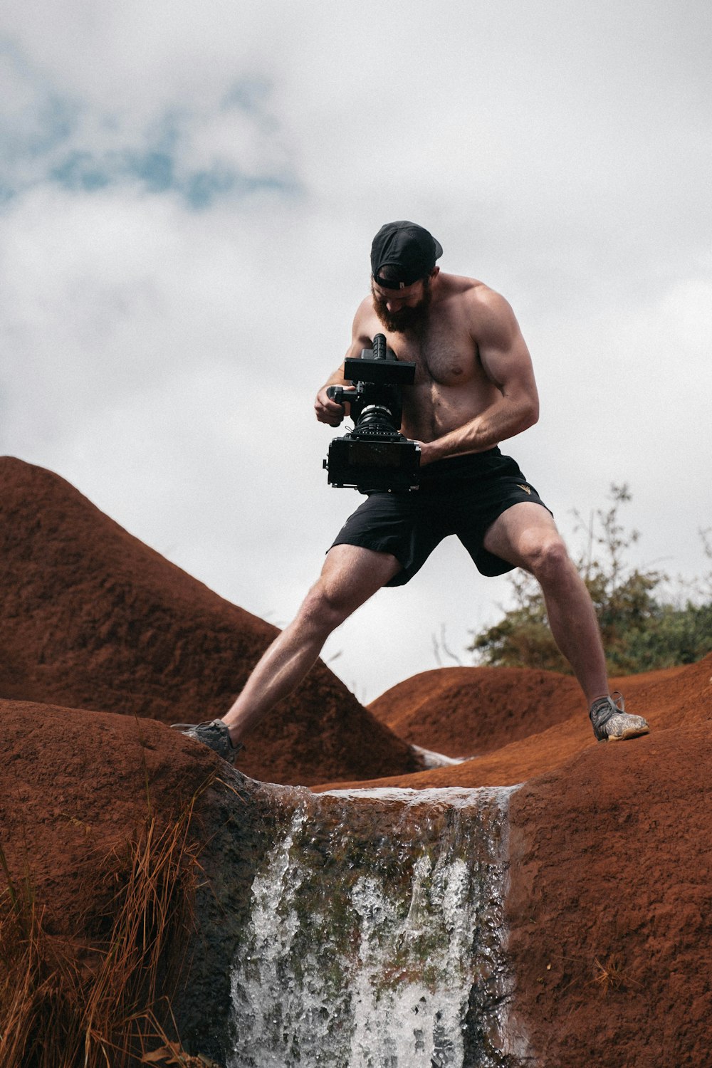 person staking video of waterfalls