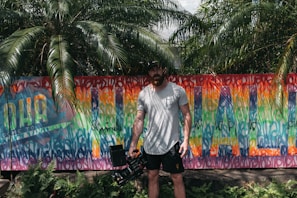 A behind-the-scenes shot of a photoshoot with vibrant Miami street art as the backdrop