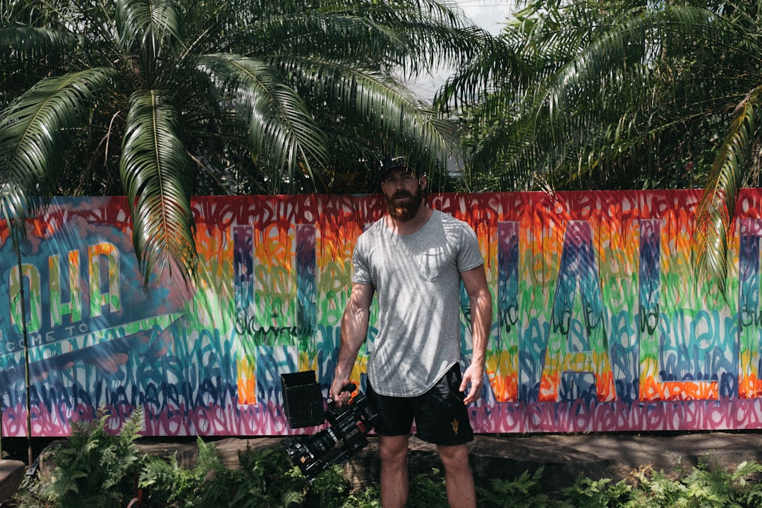 man standing near painted wall