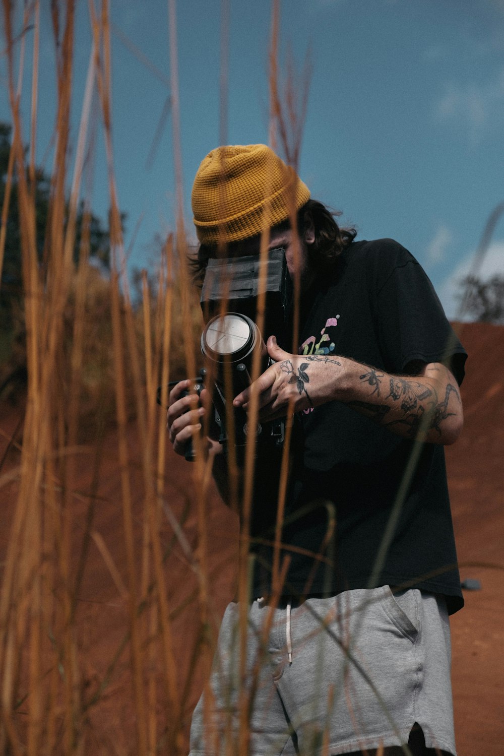 man using camera during daytime