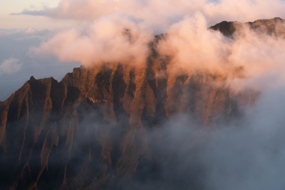 brown mountain and clouds