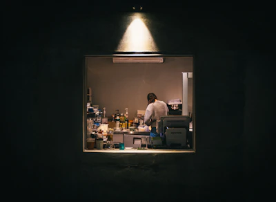 A cozy, softly lit workspace where the natural ingredients for Dermalume creams are prepared.