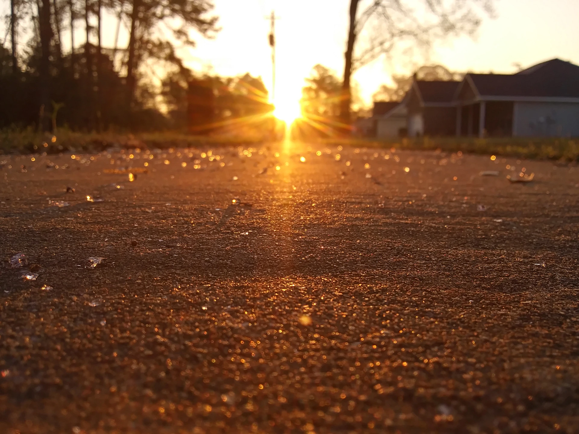 A vibrant sunrise casting warm golden light over a quiet city street, symbolizing a fresh start and daily inspiration.