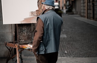 man standing near easel