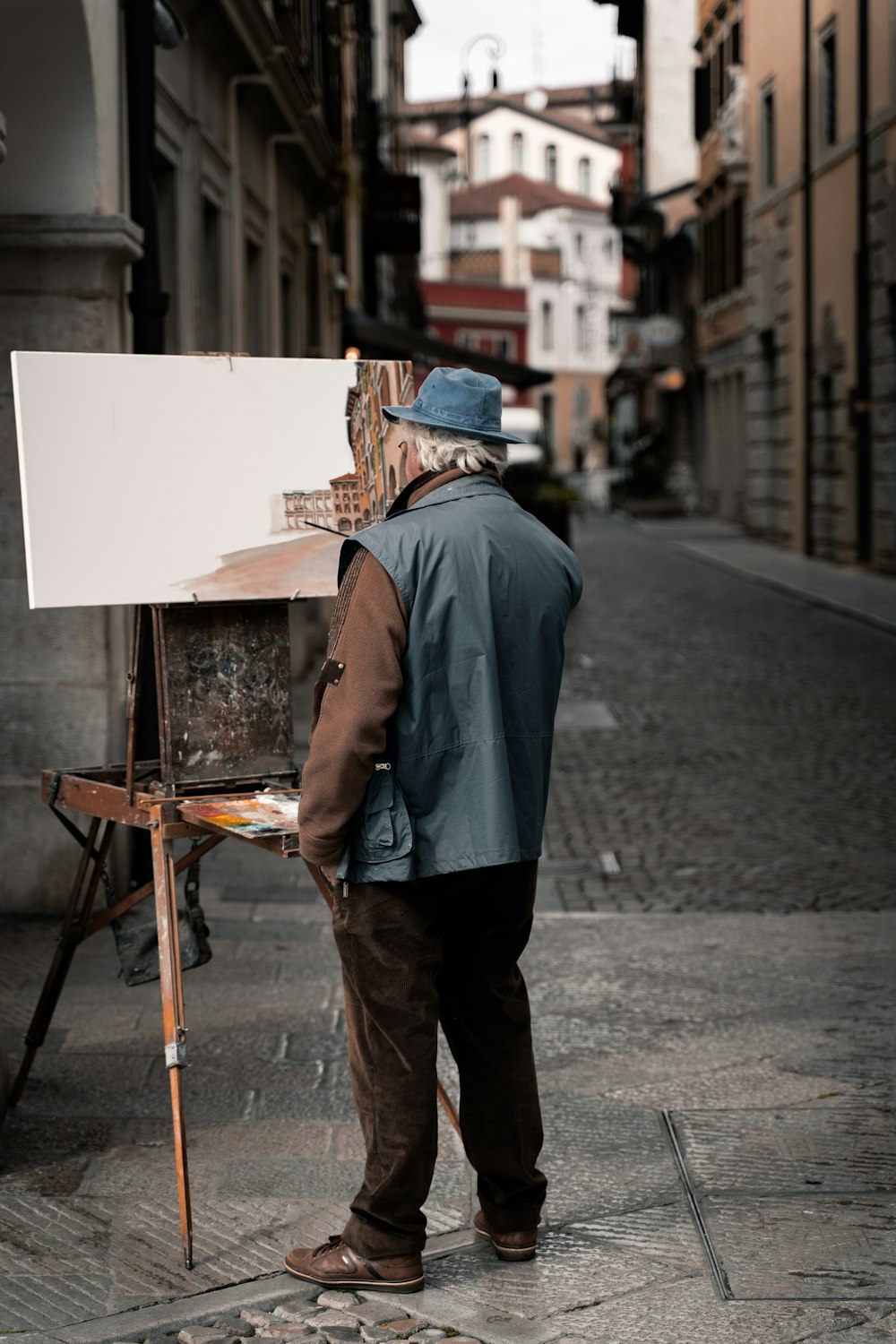 man standing near easel