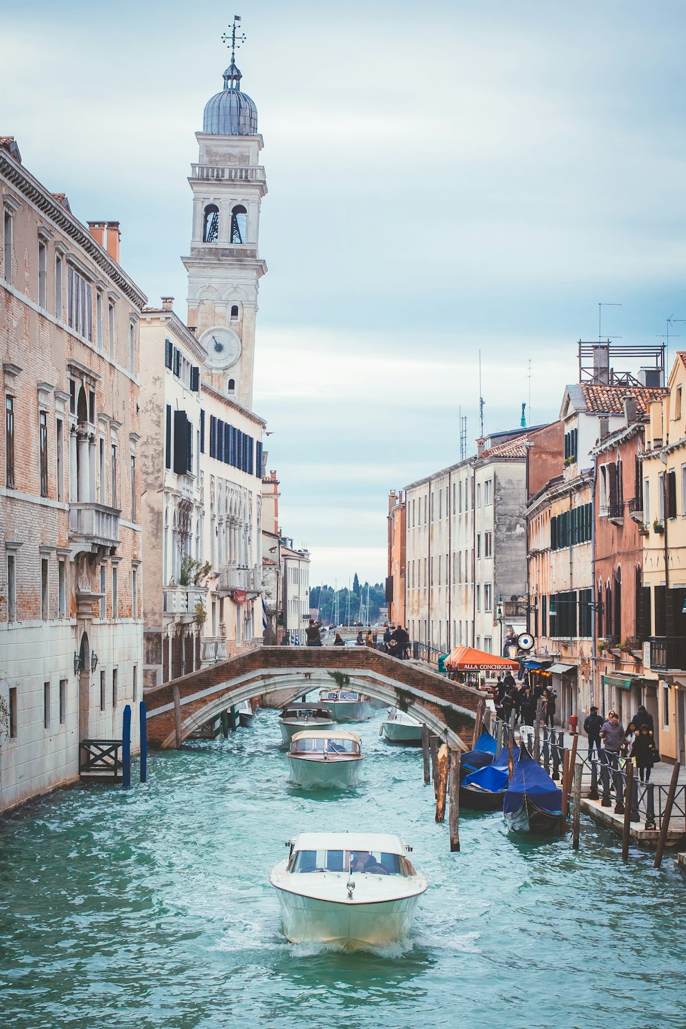 boats on canal near buildings