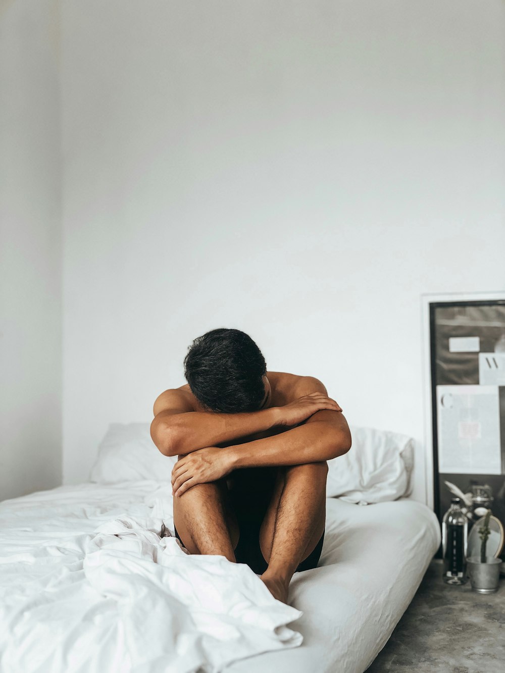 man sitting on bed