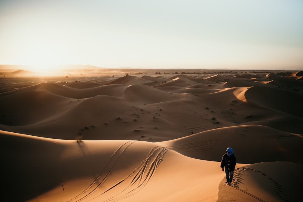 person walking on desert