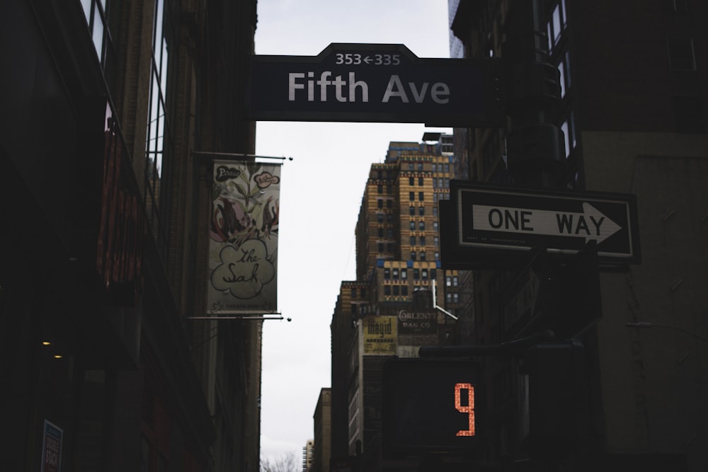 low-angle photography of road with Fifth Avenue board signage