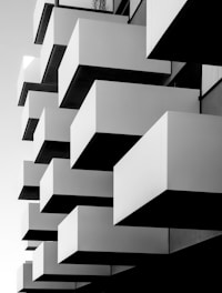 a black and white photo of a building with balconies