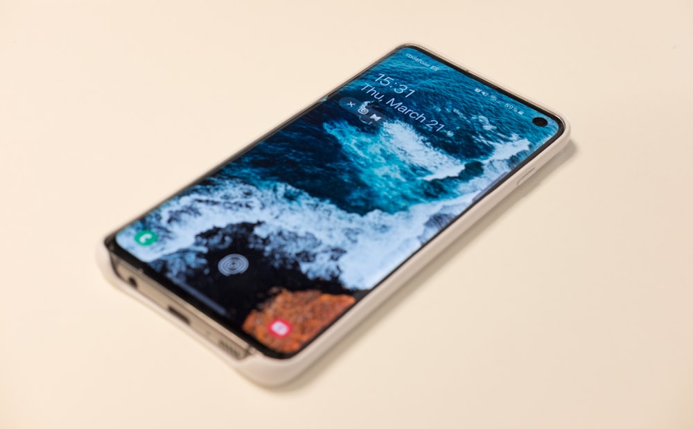 smartphone displaying ocean wave wallpaper