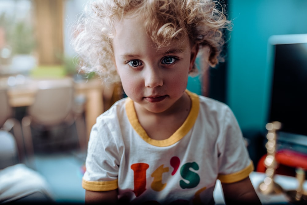 boy in white and yellow crew-neck t-shirt