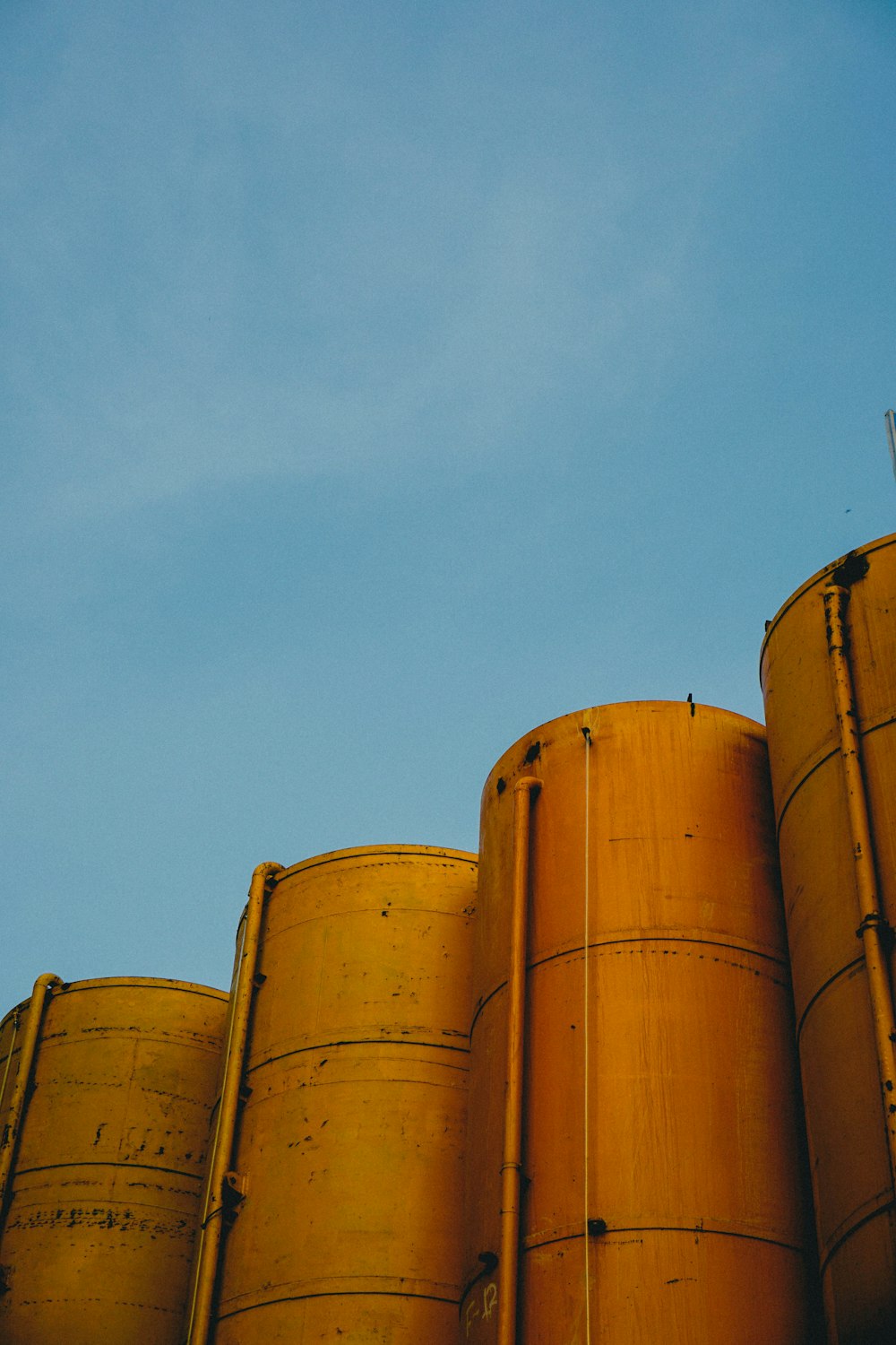 four yellow silos