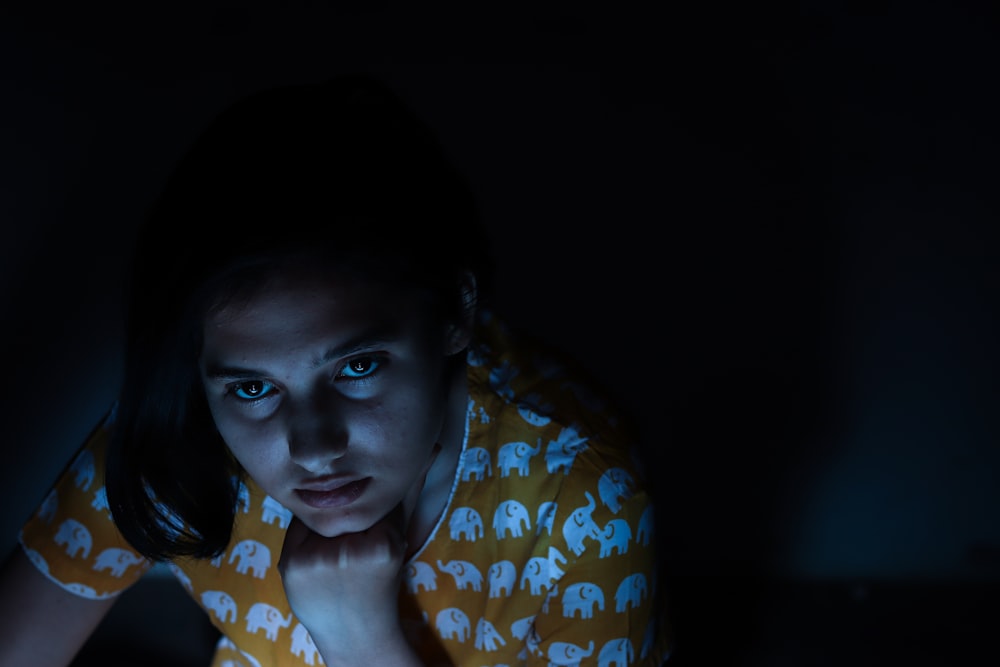 woman looking up inside dim-lit room