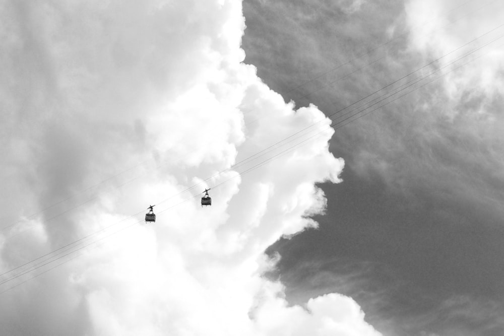 two cable cars under white clouds