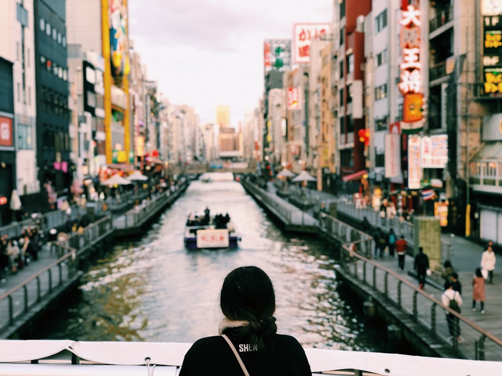 person wearing black top watching river during daytime