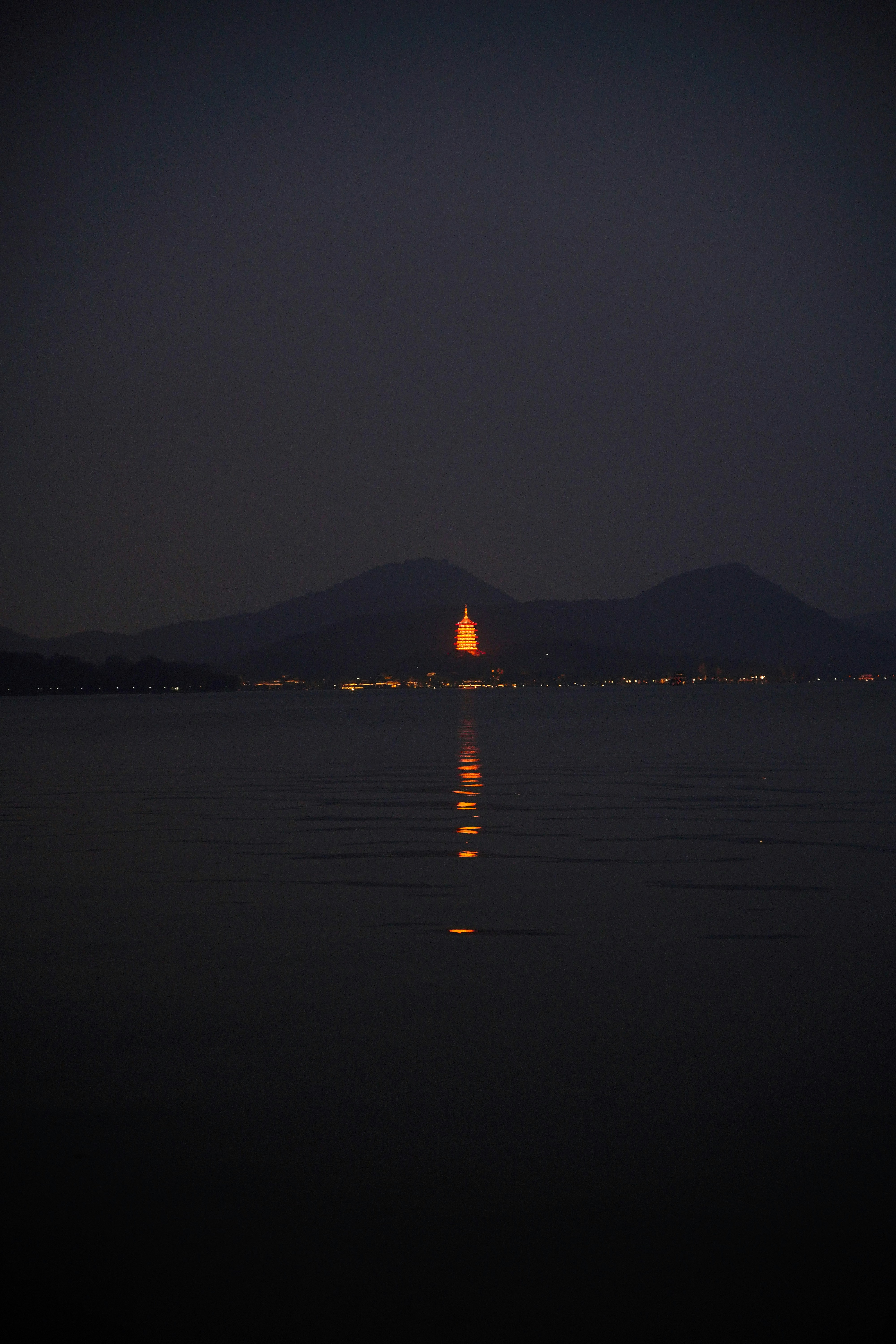 lake near mountain at night