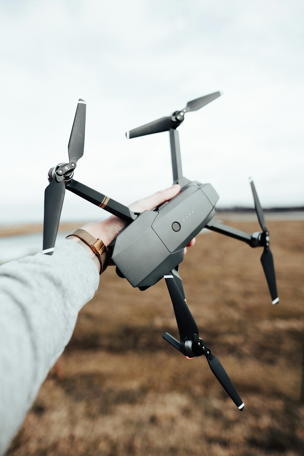 person holding black DJI Spark drone