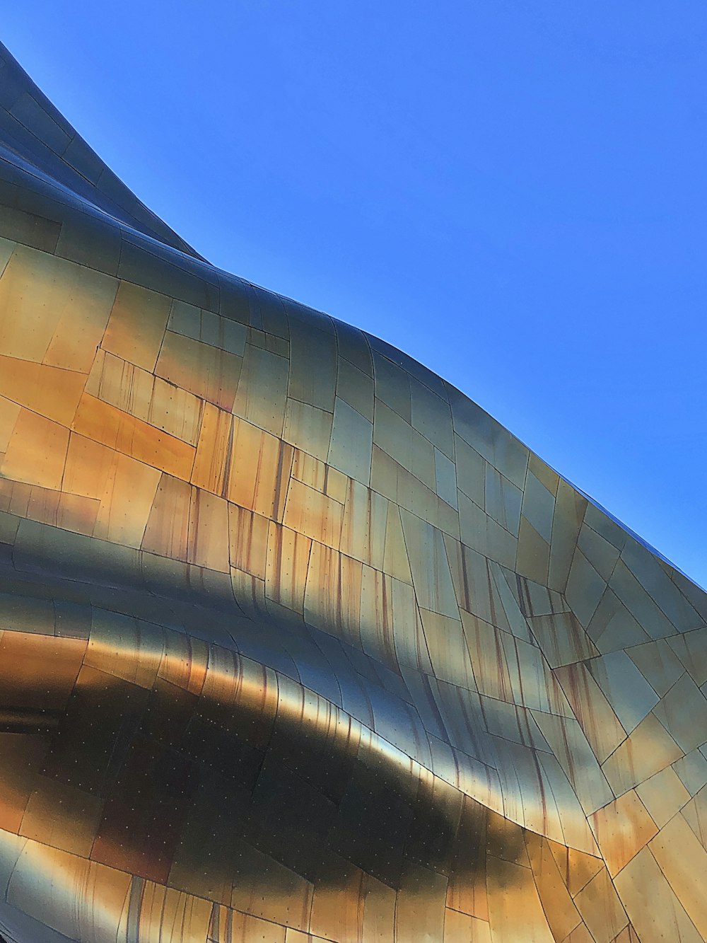 a close up of the side of a building with a blue sky in the background