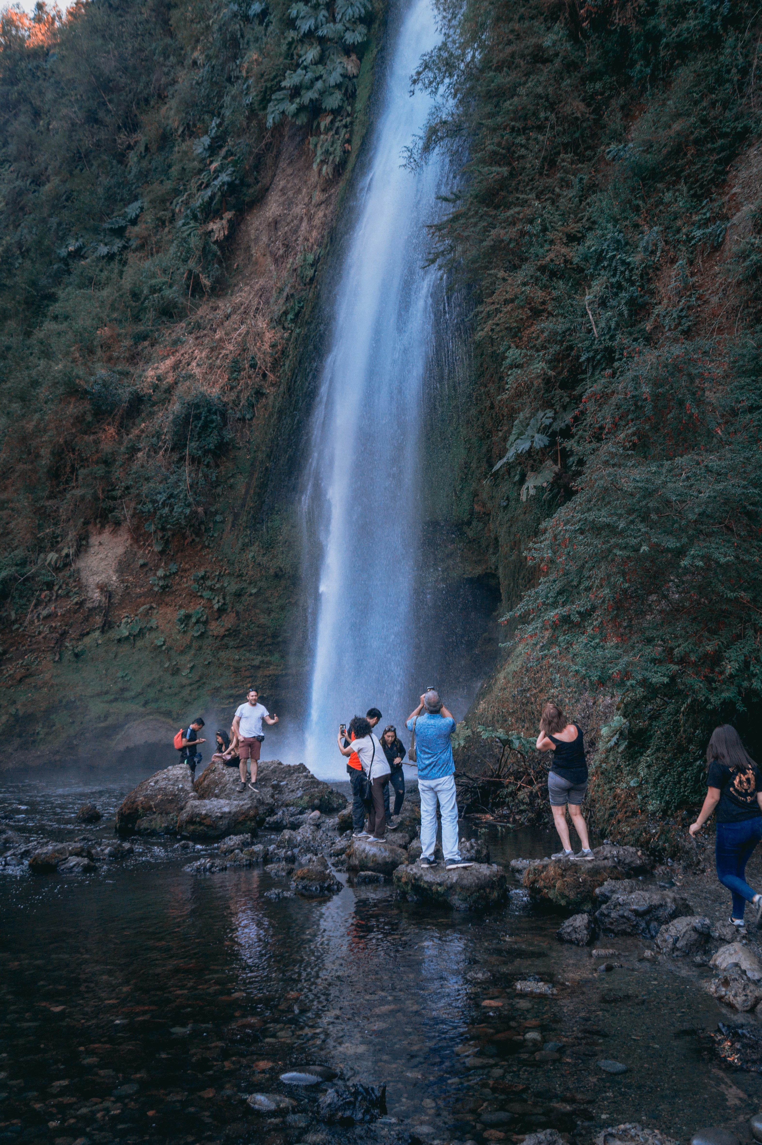 People standing beside waterfalls photo – Free Green Image on Unsplash