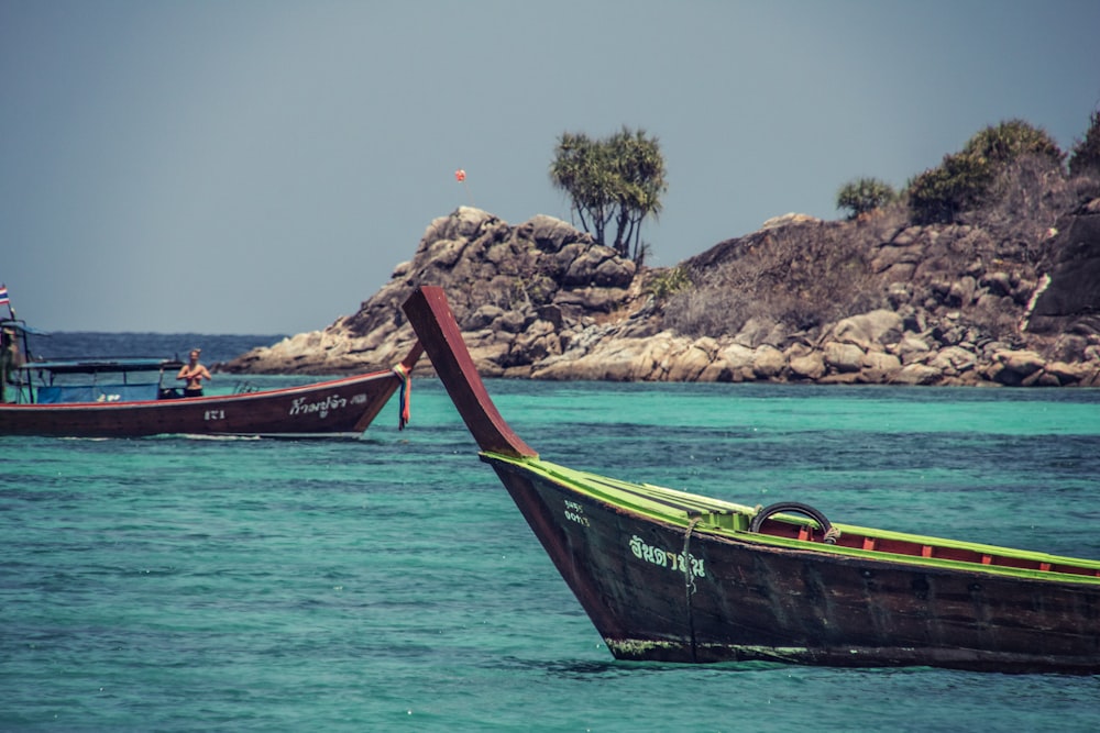 brown and green gondola on body of water